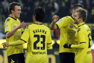 Dortmund's players celebrate after Shinji Kagawa (2nd L) scored during their German first division Bundesliga match vs 1899 Hoffenheim, in Dortmund, western Germany, on January 28. Defending champions Dortmund are looking to turn up the heat on league leaders Bayern Munich when they take on Nuremberg on Friday even though arctic temperatures are forecasted.