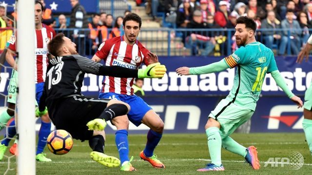 Messi haunts Atletico once more to send Barcelona top