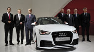 Members of the board of management of German car maker Audi pose next to an Audi A1 quattro car during the company's annual press conference in Ingolstadt, southern Germany, on Thursday. The top-of-the-range carmaker, the premium brand of Volkswagen, said that profits rose to new records in 2011, and earnings would again match those levels this year. 