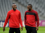 Basel's midfielder Jacques Zoua (L) and defender Genseric Kusunga laugh ahead of the final team training in Munich, southern Germany, on the eve of the UEFA Champions League round of sixteen second leg match between Bayern Munich and FC Basel.