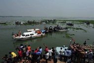 Rescuers recover the bodies of passengers after a ferry sank in Munshiganj, southeast of the Bangladeshi capital Dhaka, on March 13. The death toll reached 66 on Wednesday. Emergency teams hope a second rescue vessel that arrived during the night will enable the ferry to be brought to the surface