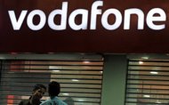 India says it will change a law to allow it to tax foreign firms for acquisitions of assets in the country after it lost a $2.2 bn fight with British mobile phone giant Vodafone