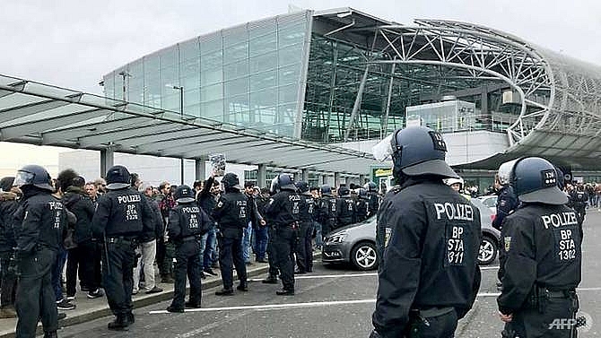 kurdish protesters clash with police at german airport disrupt uk stations