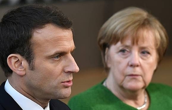 Hosting Merkel, Macron gets chance to push EU business