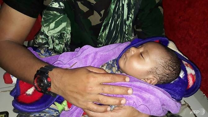 Baby reunited with dad as Indonesia flood death toll hits 77