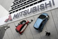 Mitsubishi cars are reflected in a mirror above a showroom in Tokyo. Mitsubishi Motors said Thursday its net profit for the fiscal year to March soared 53.2 percent, partly driven by cost cutting, even as its last-quarter results tumbled on a strong yen