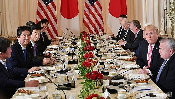 trump issues public challenge to abe on trade