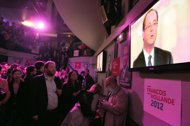 Socialist party loyalists gather to watch on TV the televised national debate between Francois Hollande and Nicolas Sarkozy at the Players bar in Paris. Nicolas Sarkozy made a last-ditch effort to revive his struggling re-election bid Wednesday, branding Socialist frontrunner Francois Hollande a 
