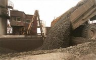 A giant truck unloads some 200 tonnes of freshly excavated rock into a 
