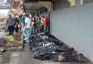 Body bags containing bodies of the victims are laid on a pavement after a fire gutted a department store in Butuan City, Agusan del Norte province, southern island of Mindanao, on May 9. Seventeen shop staff sleeping in the department store were killed when a fire swept through the building before dawn
