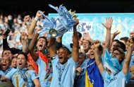 Manchester City's Belgian captain Vincent Kompany lifts the Premier league trophy after their 3-2 victory over Queens Park Rangers in Manchester on May 13, 2012. Manchester City won their first title since 1968.