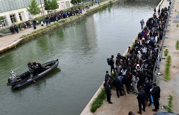 Police clear Paris camp as migrant debate flares in France