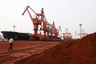 File photo shows rare earth being loaded on to a ship at a port in Lianyungang, east China's Jiangsu province. China said Wednesday its regulation of the rare earths industry was in line with international rules as it faces international pressure over its control of the crucial elements