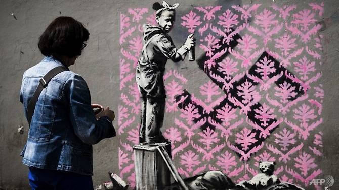 banksy needles france on migrants with paris mural blitz