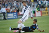 David Beckham of the Los Angeles Galaxy (top) battles for control of the ball with Justin Morrow of the San Jose Earthquakes in the first half of their MLS soccer game at Stanford Stadium on June 30, in Palo Alto, California. Beckham was suspended for one game and fined an undisclosed amount by Major League Soccer on Thursday for his actions in and after a loss last weekend. (AFP Photo/Thearon W. Henderson)