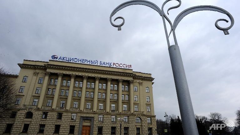 eu slaps asset freeze travel ban on putins bank rossiya associates