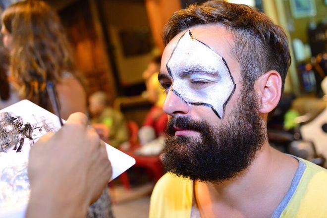 Foreign tourists enjoy face painting service in Hanoi, Hanoi old quarter, Ma May Street, walking street pedestrian streets