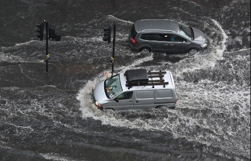 London roads flood as storms roll in