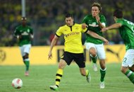 Champions Dortmund down Bremen to open 50th season