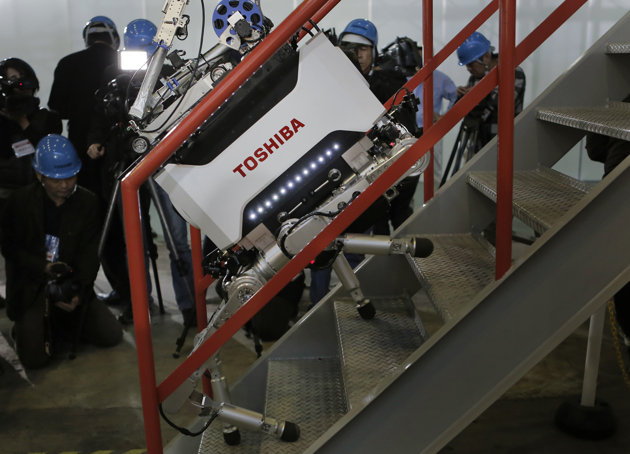 Toshiba Corp.'s nuclear Inspection robot climbs stairs during a demonstration at a Toshiba factory in Yokohama, west of Tokyo, Wednesday, Nov. 21, 2012. The four-legged robot is designed to help at the meltdown-crippled Japanese nuclear plant, climbing over debris and venturing into radiated areas off-limits to human workers. (AP Photo/Itsuo Inouye)