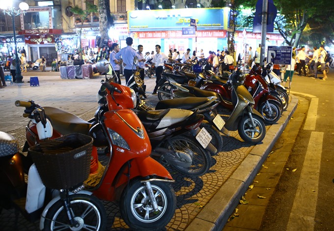 On-street parking damages pavements in Hà Nội