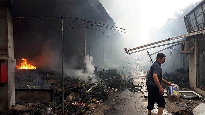dozens of groceries in hanoi market were burned down
