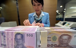 Malaysian, Thai economies suffer as currencies slide