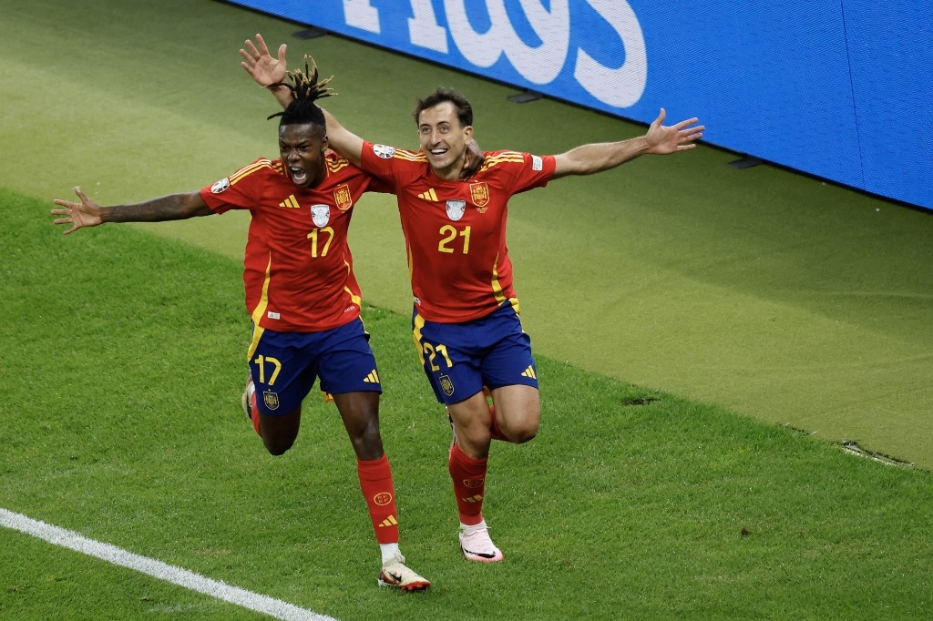 Spain's midfielder #21 Mikel Oyarzabal celebrates with Spain's midfielder #17 Nico Williams after scoring his team's second goal during the UEFA Euro 2024 final football match between Spain and England at the Olympiastadion in Berlin on July 14, 2024. Odd ANDERSEN / AFP
