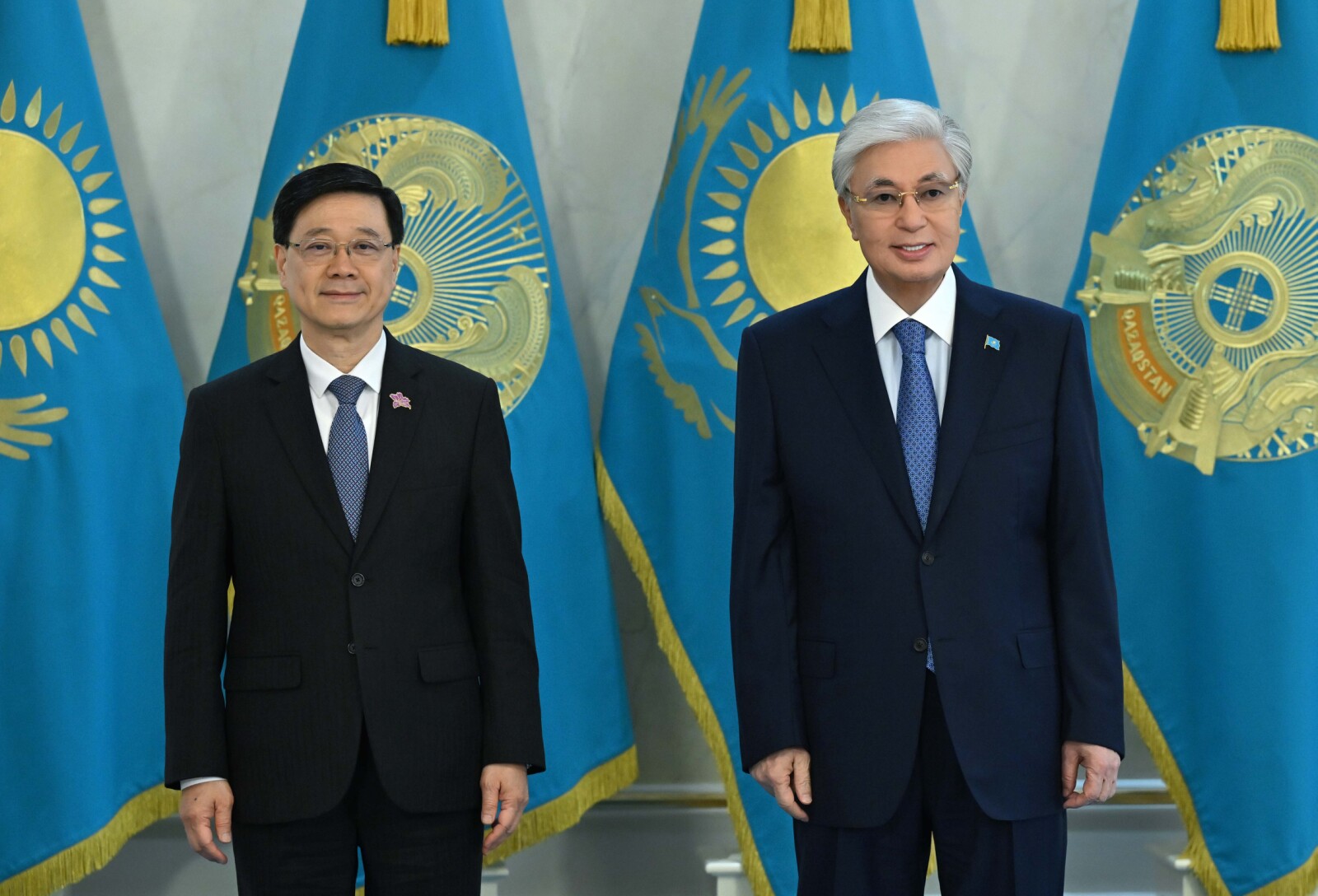 Hong kong sar's chief executive john lee (left) meets with the president of kazakhstan kassym-jomart tokayev to exchange views on deepening bilateral relations.