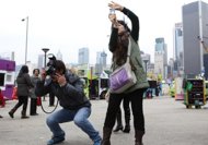 Mainland Chinese tourists take photos in Hong Kong on January 6, 2012. Tourist arrivals reached a historic high in Hong Kong in 2011 with nearly 42 million visitors, boosted by increases mainly from mainland China and South Korea, tourism officials said