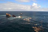 The stern section of the Rena falls off of Astrolabe Reef and starts to sink leaving behind the front section after being damaged in a storm where it was pounded by high seas off the coast of Tauranga, on January 10. The Rena had been stuck on the reef since last October