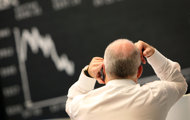 A trader works at the stock exchange in Frankfurt, 2011. European stock markets and the euro fell on stubborn fears over the plight of debt-ridden Greece, before a key EU summit that will seek to focus on restoring economic growth