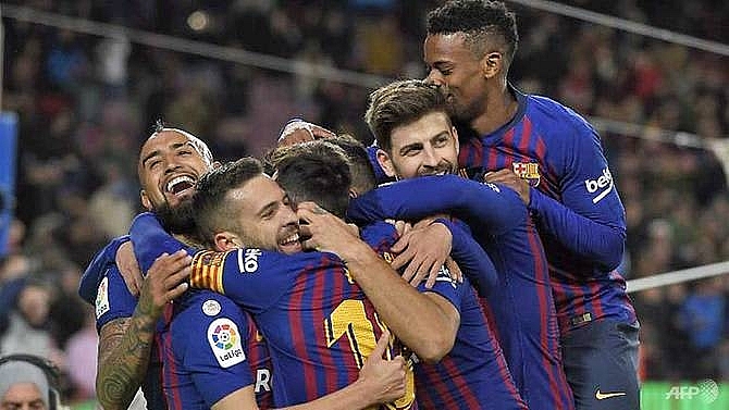barcelona hit sevilla for six to book semi final place