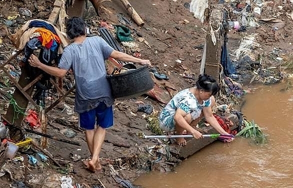 At least 60 dead and thousands in shelters as floods hit Indonesia