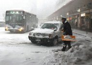 A worker removes snow at the entrance to the JR Niigata Station in Niigata prefecture on February 2, 2012 as a cold front dumps heavy snow on many parts of the country. At least 55 people have died as a result of the heavy snow storms in northern Japan