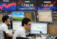 Traders monitor exchange rates in a dealing room at the Korea Exchange Bank in Seoul, 2011. Asian stocks rose, shrugging off concerns about the eurozone's debt crisis as a batch of rosy US economic data buoyed investor sentiment with the Dow hitting a near four-year high