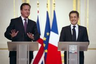 France's President Nicolas Sarkozy (right) and British Prime Minister David Cameron hold a press conference at the Elysee Palace on Friday. The pair put recent disputes behind them Friday to unveil a nuclear power deal and renew their own sometimes shaky political alliance