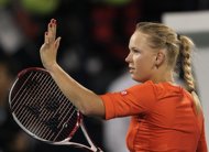 Denmark's Caroline Wozniacki celebrates after beating Serbian's Ana Ivanovic during their WTA Dubai Open quarter-final tennis match in the Gulf emirate. Wozniacki aims to win a bet with golfer boyfriend Rory McIlroy over their eating habits which she hopes will help her climb back to world number one. 