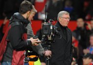 Manchester United manager Alex Ferguson (R) leaves the pitch after their UEFA Europa League round of 32 second leg match against Ajax at Old Trafford in Manchester, north-west England, on February 23. Fergie saw his team beaten 2-1 but a 2-0 first leg lead carried United through in nervous fashion. 