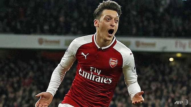 ozil commits to three year arsenal deal