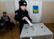 A navy sailor casts his ballot in the presidential election at a polling station in the Russian Far East city of Vladivostok. Russians started voting Sunday in presidential polls likely to return strongman Vladimir Putin to the Kremlin for a record third term amid a wave of protests unseen for decades. 