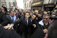 France's President Nicolas Sarkozy (C) walks surrounded by bodyguards in a street of Bayonne during his campaign visit on March 1, 2012 in the Basque country, southwestern France. The Basque separatist group ETA urged France to open direct talks on a definitive end to its conflict with the French and Spanish states, in a statement released to AFP on Friday.