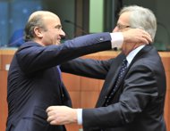 Spanish Finance Minister Luis De Guindos (L) and Luxembourg Prime Minister and Eurogroup president Jean-Claude Juncker hug after a joke prior an Eurozone meeting at the EU headquarters in Brussels. Spain wrung a major concession from the eurozone Monday, winning leeway in its struggle to tame a runaway public deficit amid rampant unemployment.
