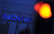 Mobile phone maker Nokia is seeking a US patent for tattoos that vibrate to let people know when they have calls on their mobile phones. (AFP Photo/Michael Gottschalk)