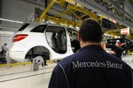 Local workers prepare to complete a car in the new factory of German carmaker Daimler AG Mercedes-Benz in Kecskemet, about 90 km east of Budapest. 