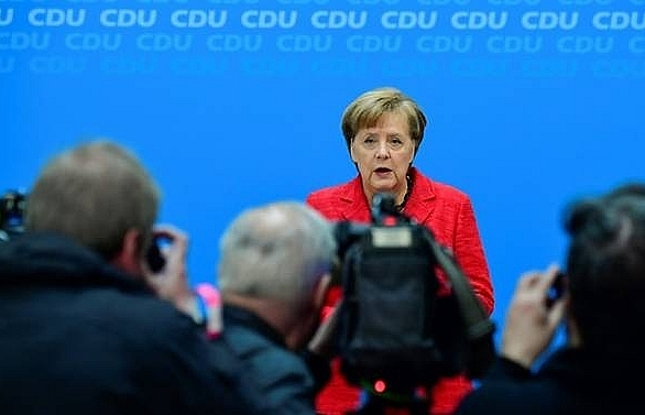 merkel vows swift return to government work to boost europe