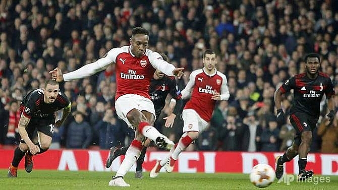 welbecks double helps arsenal past milan dortmund dumped out