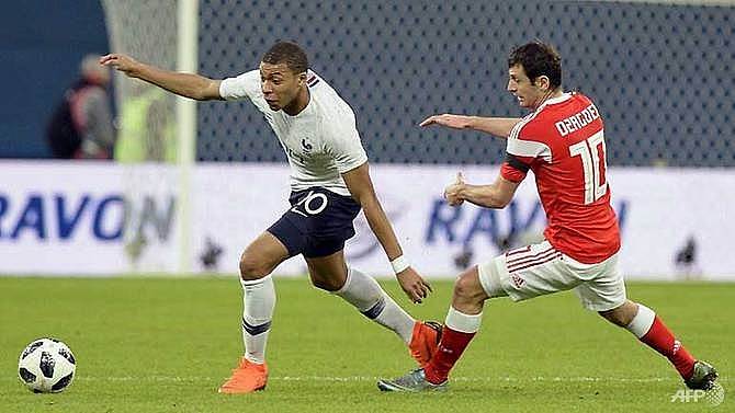 mbappe shines as france cruise past russia