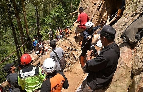 Eight dead in Indonesia mine collapse as excavator digs for survivors