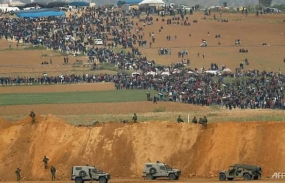 Four killed as thousands protest at border, but Gaza-Israel truce holds